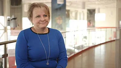 Go Insurance A woman in a blue dress sitting for an interview