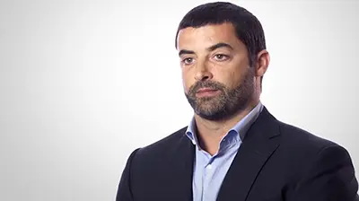 MLS Insurance Brokers Inc. A man in a suit in an all white room