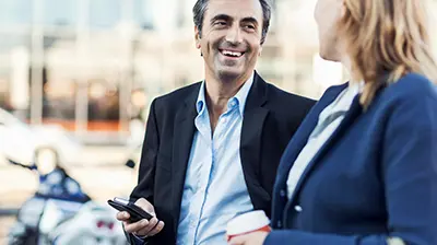 How Digital Agencies Deliver Enhanced Customer Satisfaction A man and a woman talking to each other while standing outside