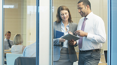 The Digital Brokerage: Developing a Digital Transformation Plan Two people working together in the foreground with other colleagues in the background