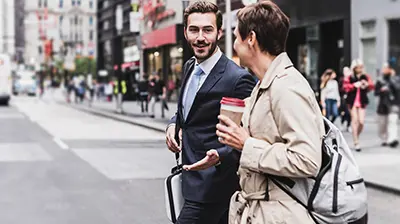 The 5 Benefits of Being a Digital Agency: Advice Two men, dressed in business attire, crossing a street while having a discussion