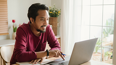 The Digital Ecosystem of Insurance A man sitting at a table while using his laptop