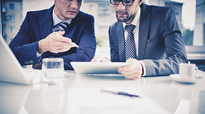 Change Management for Success Two businessmen looking over a document